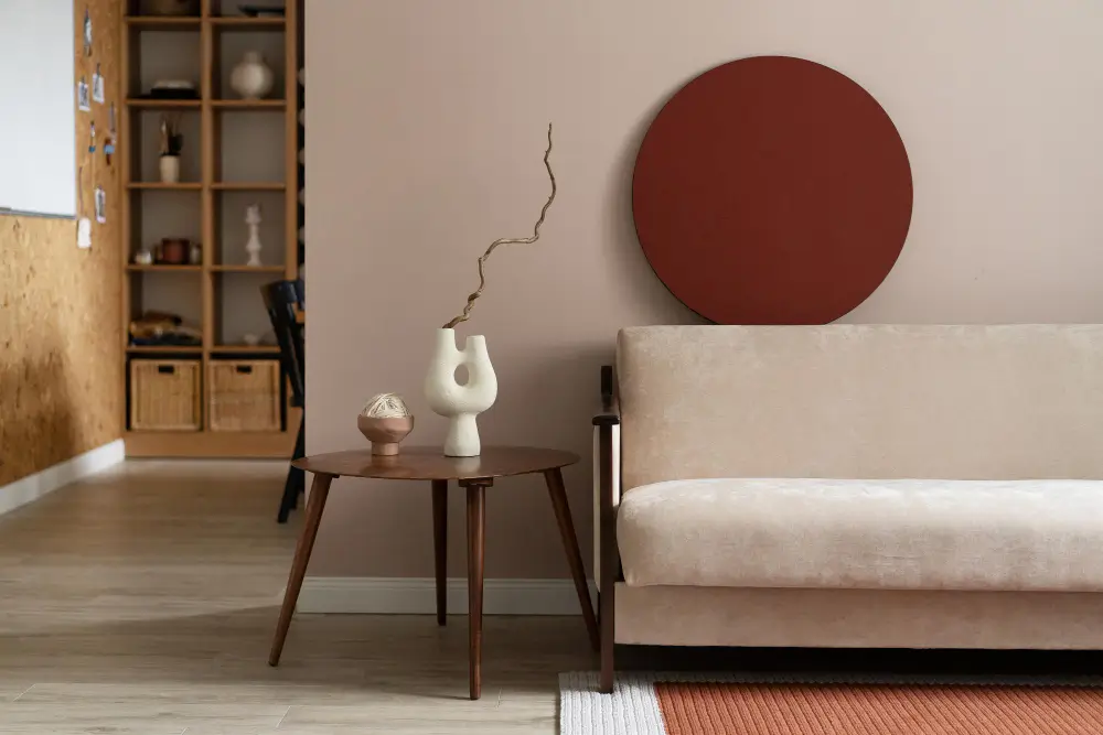 . A cozy living room featuring a comfortable couch, a stylish table, and a decorative round object on display.