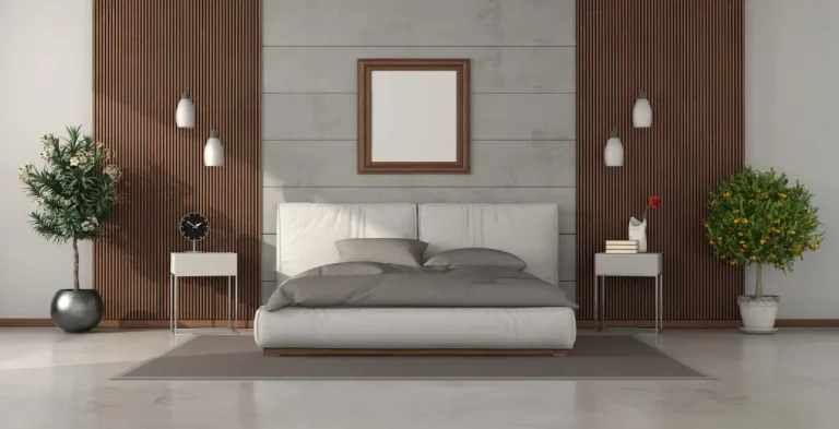 A modern bedroom featuring a wooden accent wall and a stylish white bed, creating a serene and inviting atmosphere.